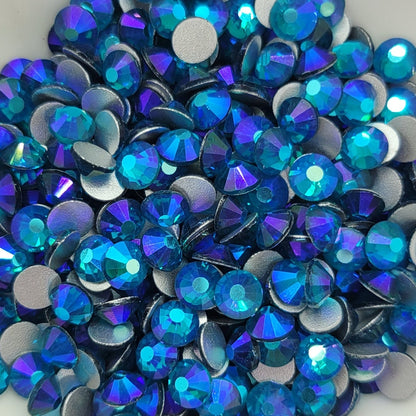 Blue Zircon AB rhinestones in a white dish on a light purple background