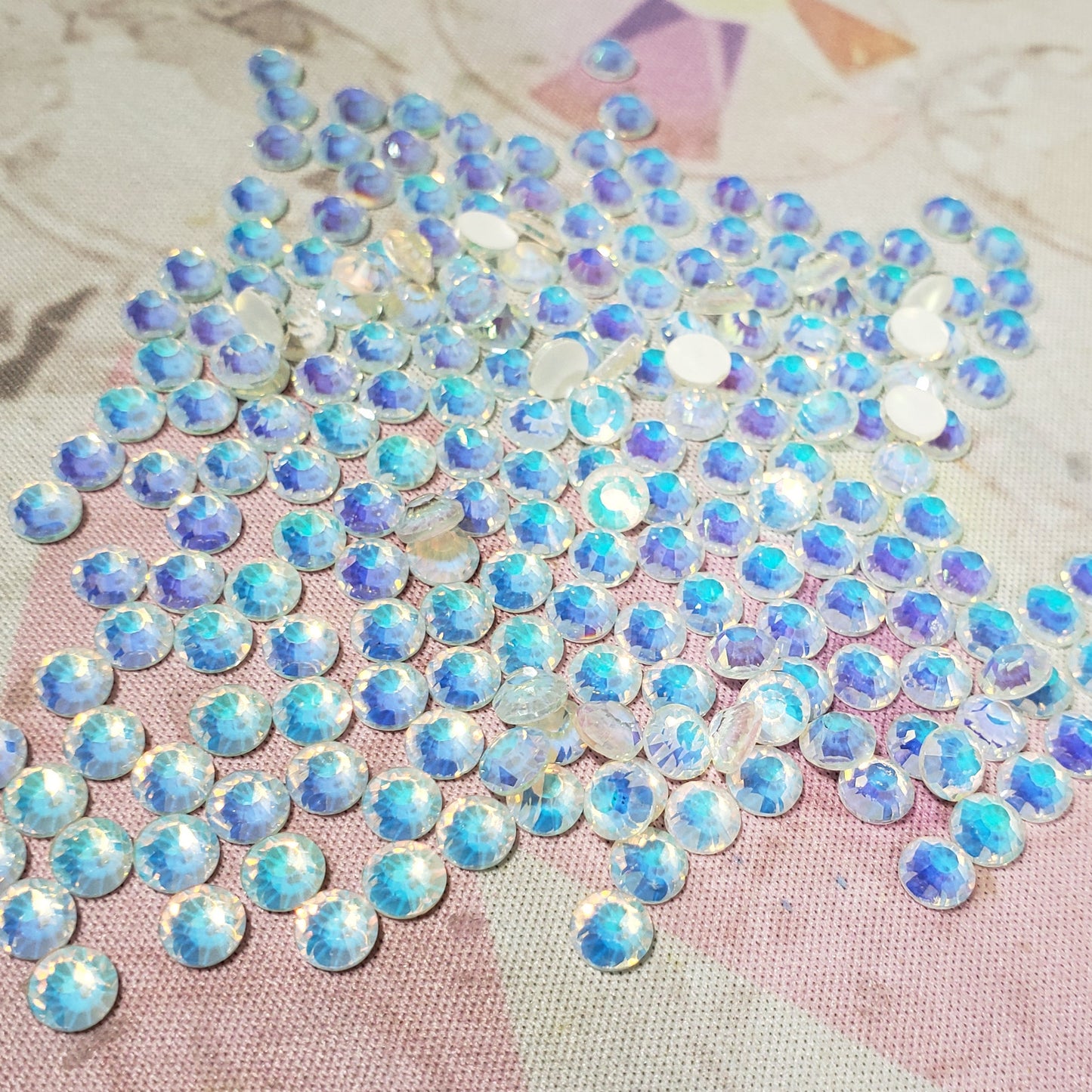 Iridescent rhinestone patch on a textured fabric background