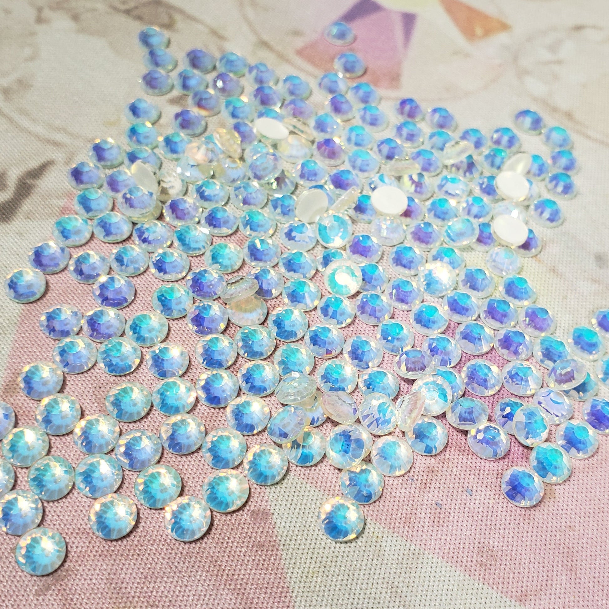 Iridescent rhinestone patch on a textured fabric background