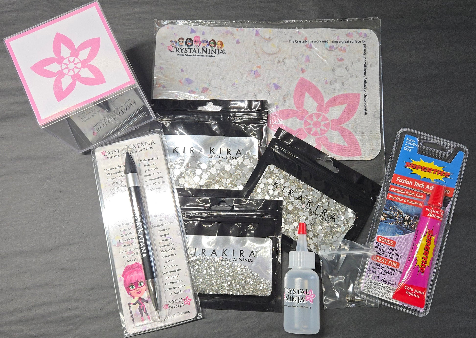 Collection of nail art supplies including a pen, bottle, and packaging on a gray surface.