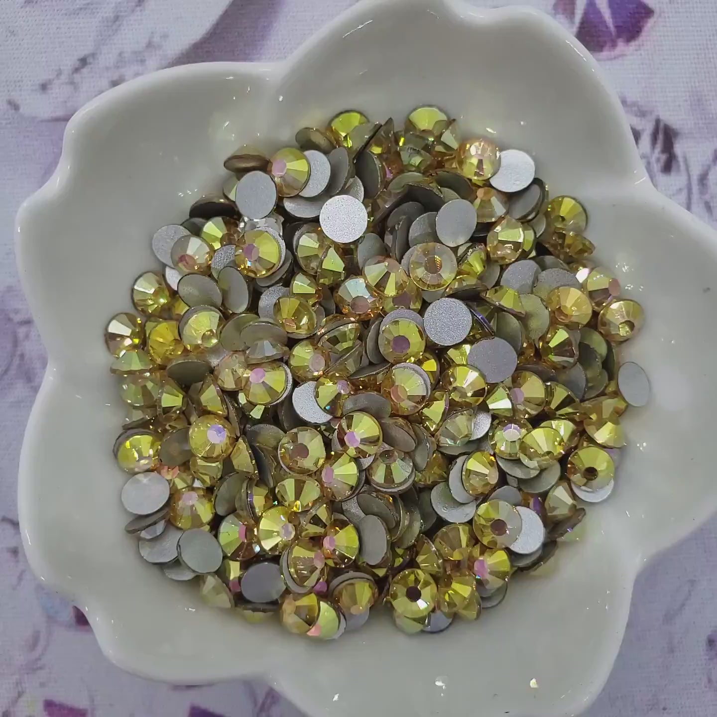 Video of Sunny Gold Rhinestones in a glass bowl turning and sparkling