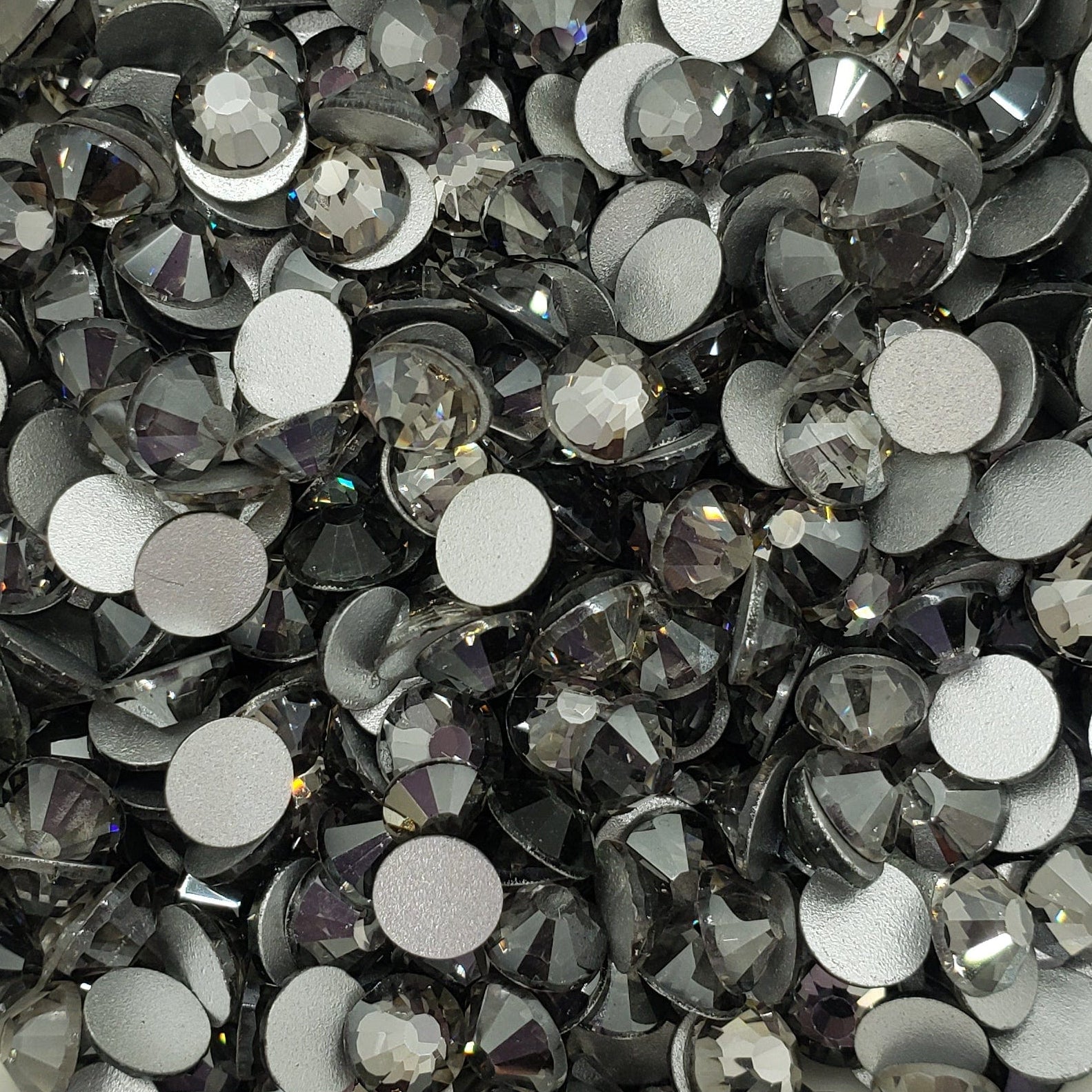 A bowl filled with black flatback glass rhinestones