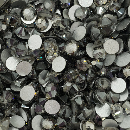 A bowl filled with black flatback glass rhinestones