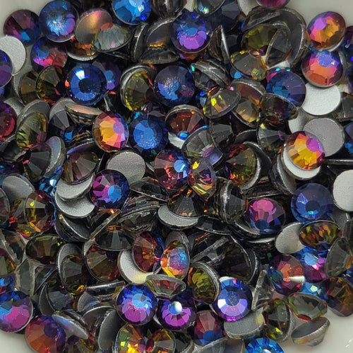 A bowl filled with multicolored blue flame glass rhinestones.