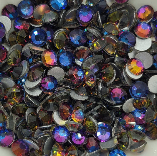 A bowl filled with multicolored blue flame glass rhinestones.