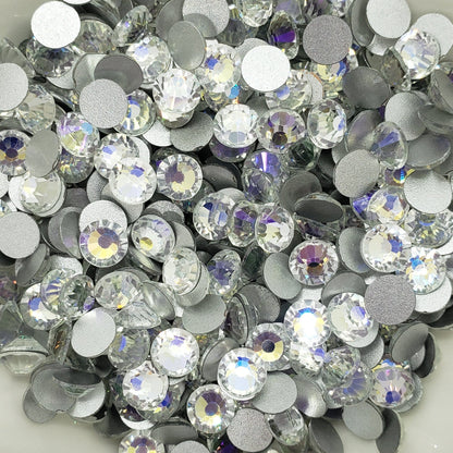 A bowl filled with round blue and clear foiled flatback rhinestones.