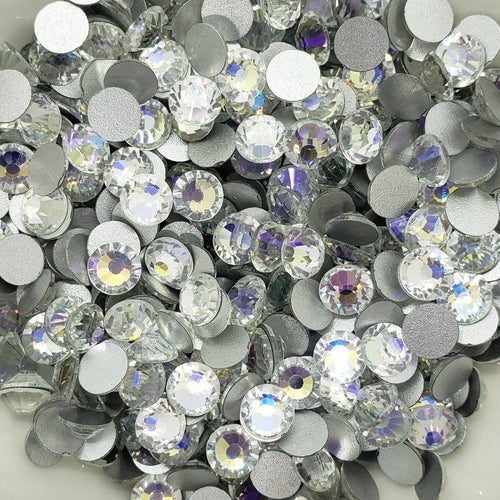 A bowl filled with round blue and clear foiled flatback rhinestones.