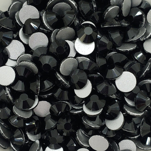 A bowl filled with black flatback glass rhinestones.