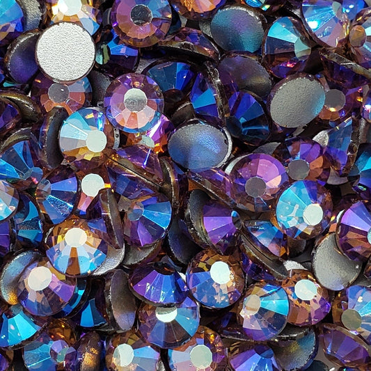 A dish containing multicolored glass rhinestones with an aurora borealis effect.