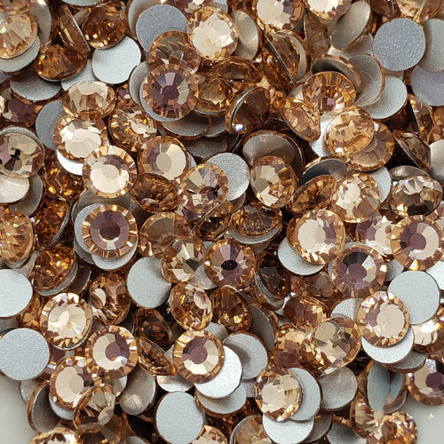 A bowl of Lighjt peach colored flatback glass rhinestones.