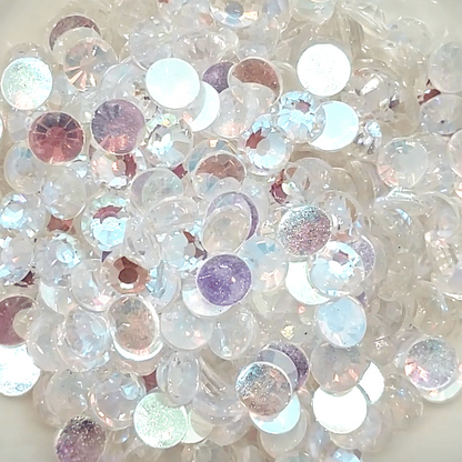 A bowl filled with round, pink champagne colored glass rhinestones.