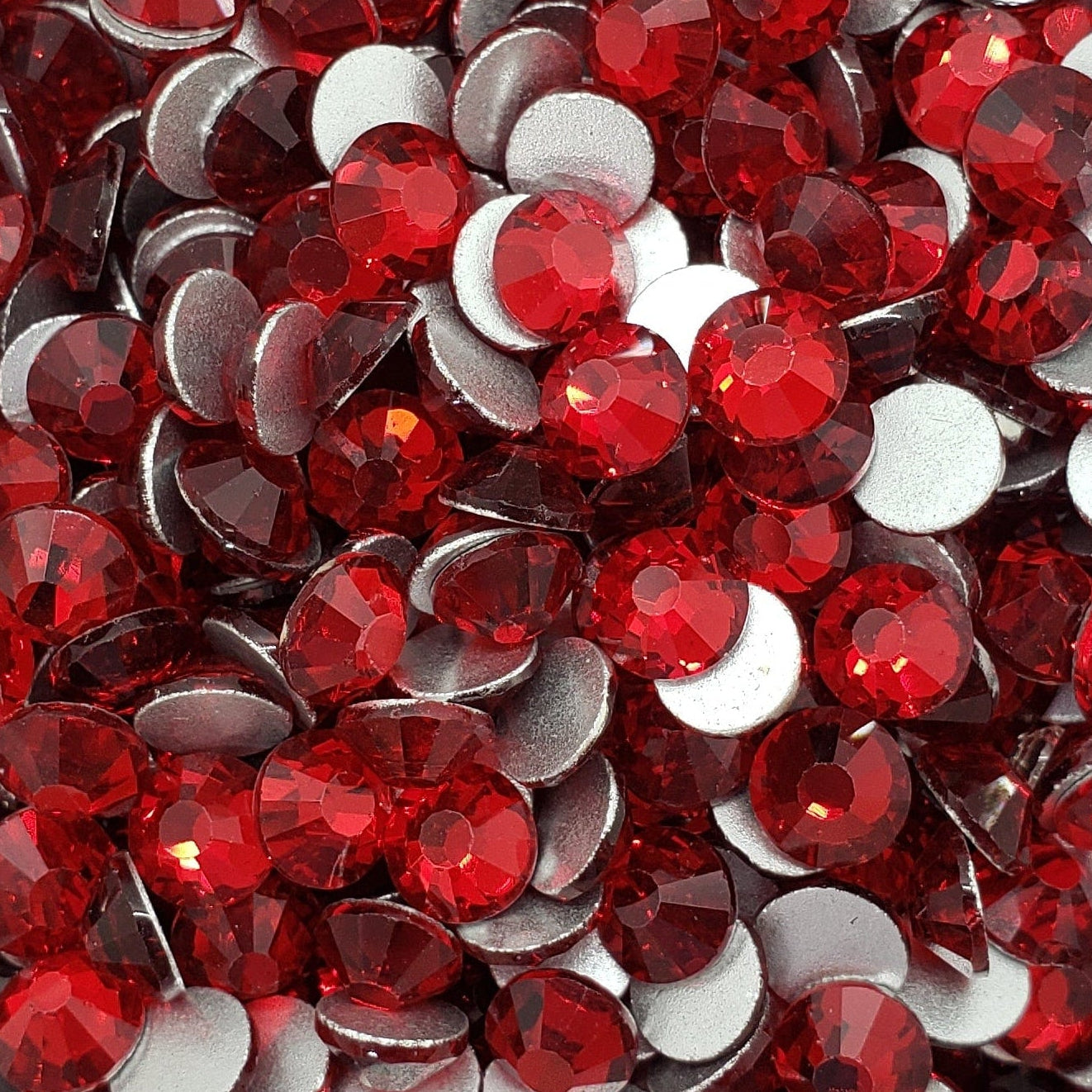 White bowl filled with red and white round stones on a patterned background