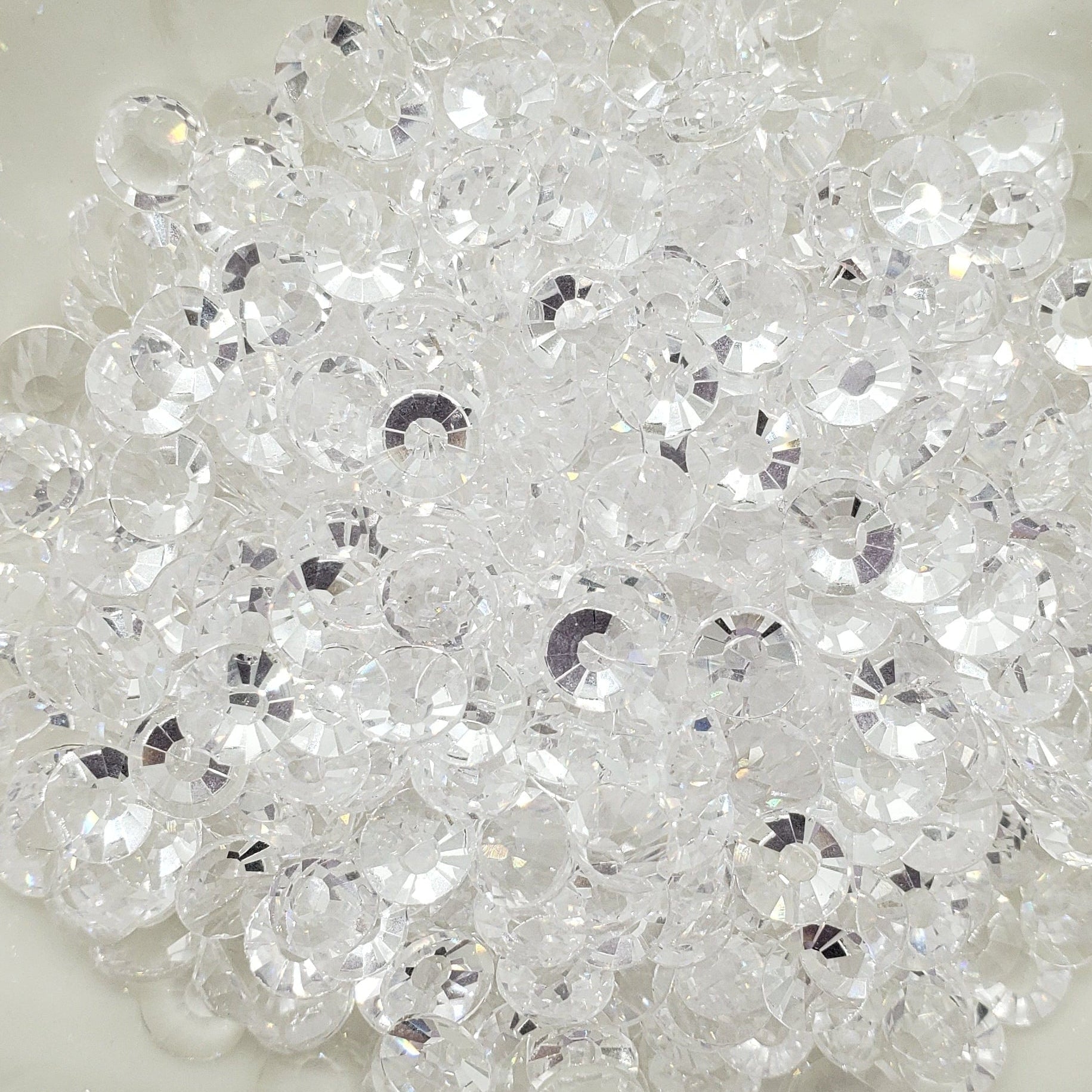 A plate of transparent clear glass rhinestones.